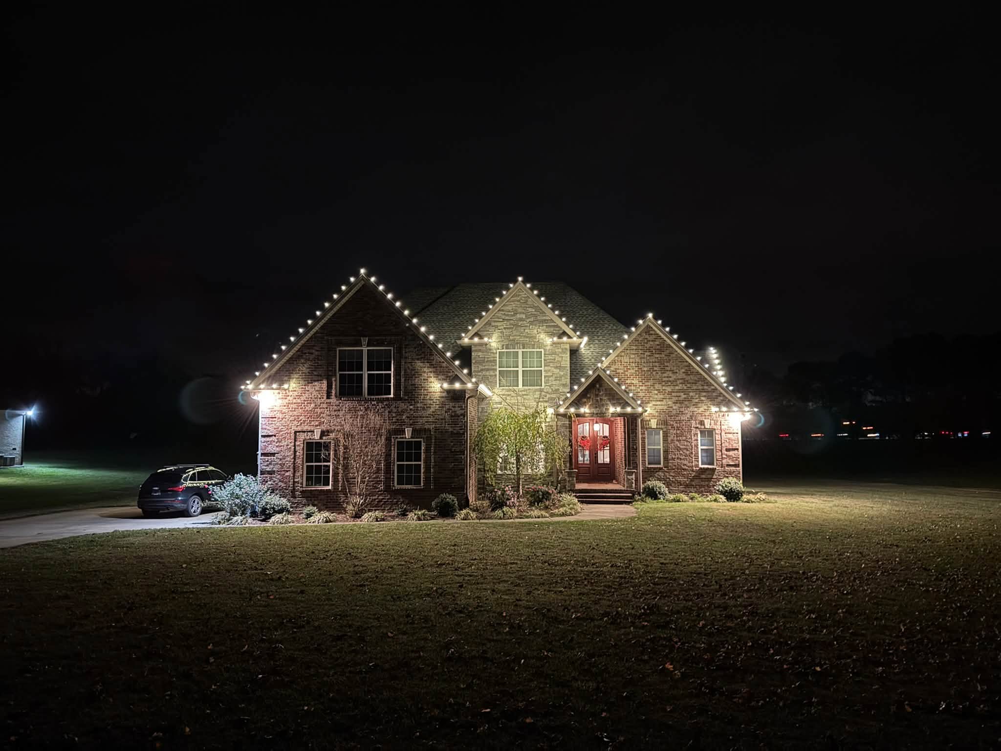 Warm white Christmas lights on a brick home in White House, TN