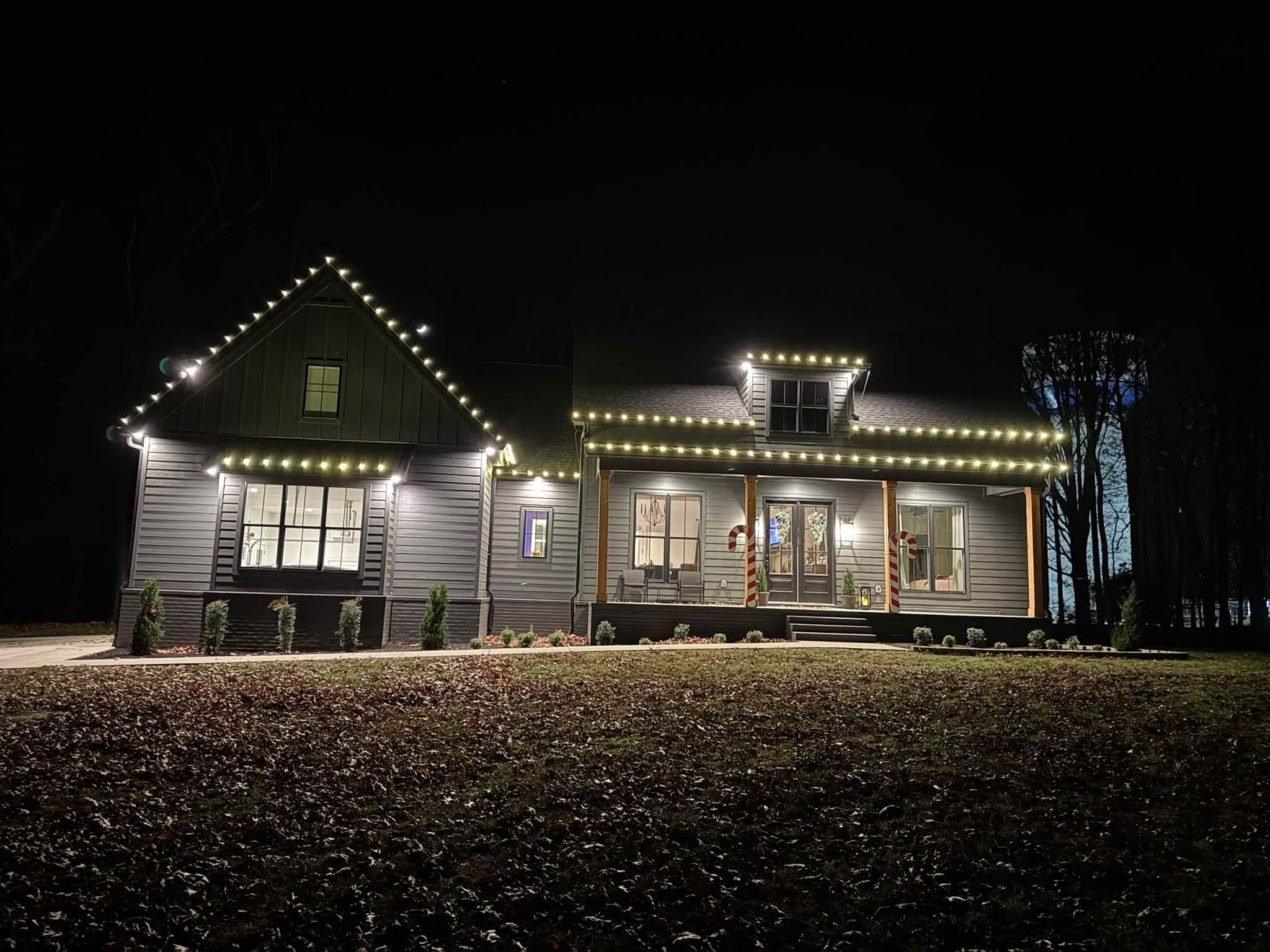 Warm white roofline Christmas lights with candy canes